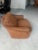 Vintage sculptural lounge chair featuring a distinctive rounded silhouette and richly textured brown ribbed upholstery....