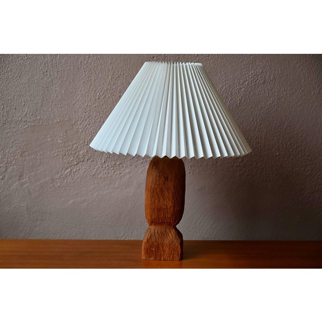 with its superb hand-carved solid teak base, this stunning Danish lamp embodies the history of 1960s Scandinavian...