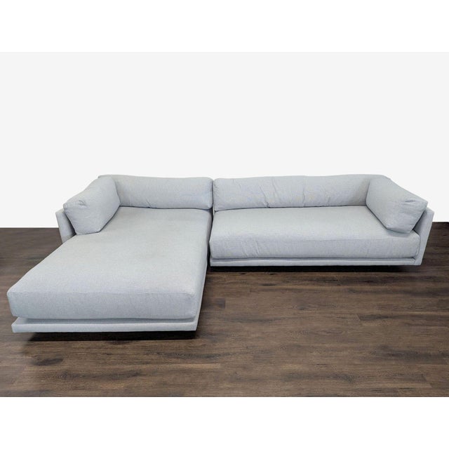 Upgrade your living space with this Blu Dot sectional sofa. It features a modern design with clean lines and a light gray...