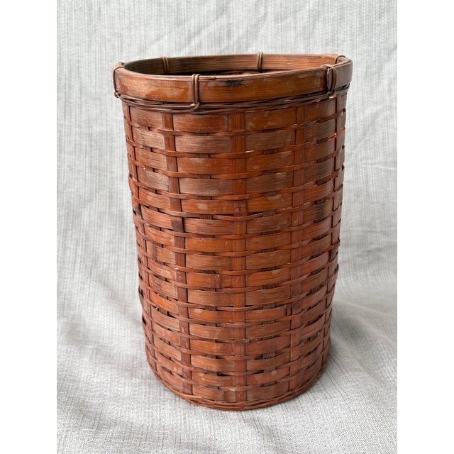 Small vintage woven bamboo wastebasket. Very good condition. Basket measures 7" in diameter by 10 1/2" in height. Thank...