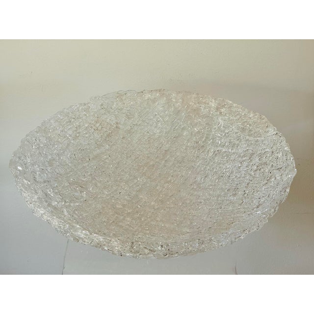 An impressive large blown glass centerpiece bowl. The intricate layers of strands of clear glass are layered in a web...