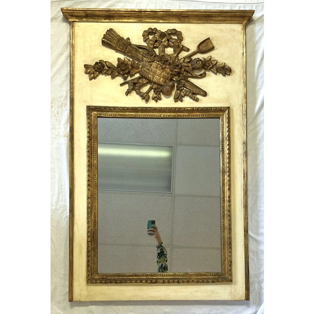 Lovely vintage Italian Trumeau mirror. The piece is made of heavy carved wood with a beige speckled background. The raised...