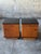 An Art Deco period pair of nightstands. Caramel wood with a black laquer top and trim. One large drawer and one large...