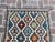 Brighten up your space with this stunning handwoven wool kilim, featuring a colorful tribal diamond design. The intricate...