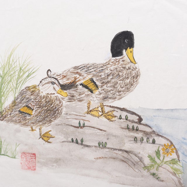 This charming watercolor is composed in the style of traditional ink calligraphy and depicts two ducks resting on a river...