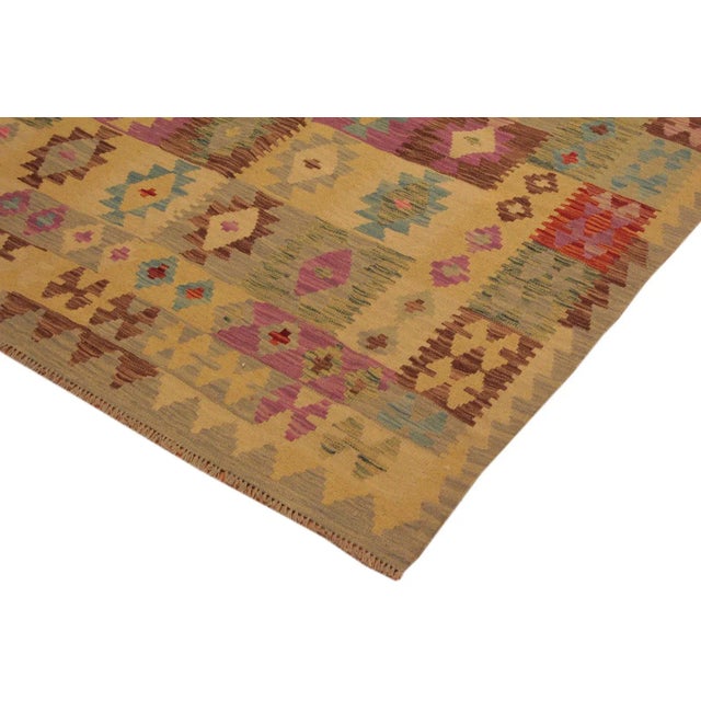 Add a touch of elegance to your home with this casual chic hand woven Tribal Kilim wool rug. Constructed on a loom by...
