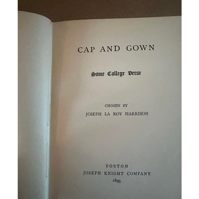 A charming antique decorative volume titled Cap and Gown and Some College Verse, featuring an exquisite floral cloth...