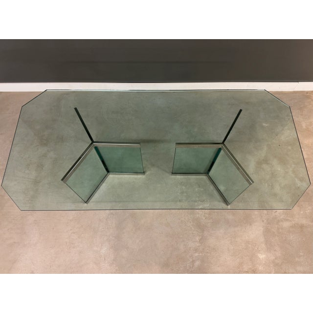 A post modern glass dining table with chrome details designed by Leon Rosen for Pace Collection. Circa 1970’s. Made in...