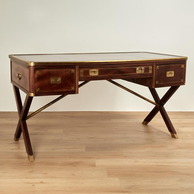 Handsome antique British colonial desk with a tooled ox blood leather top on a banded case with three drawers having brass...