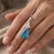 This exquisite pendant features a stunning pear-shaped blue topaz gemstone, radiating a brilliant, icy-blue hue that...
