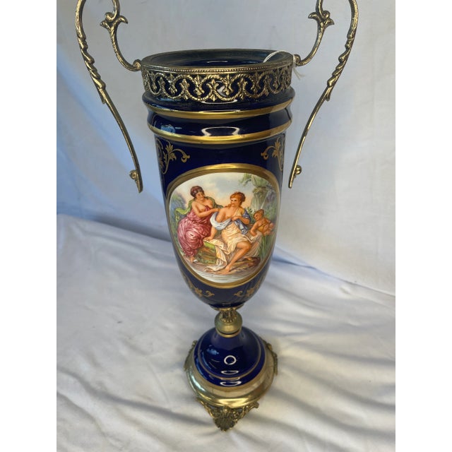 Late 1800’s early 1900’s, French, Sevres style cobalt blue painted urn vase with metal accent handles and base.