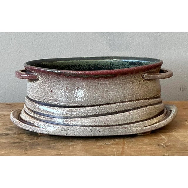 This unique vintage studio pottery piece embodies the rustic yet sophisticated craftsmanship of the Mid-Century Organic...