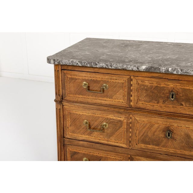 An 18th century french walnut commode with three drawers. of louis xvi inspiration, this handsome commode is veneered in...