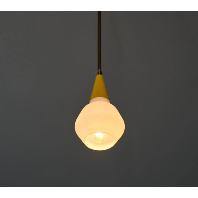 Italian midcentury ceiling pendant light, crafted in the 1950s with a fusion of timeless elegance and modern design. This...