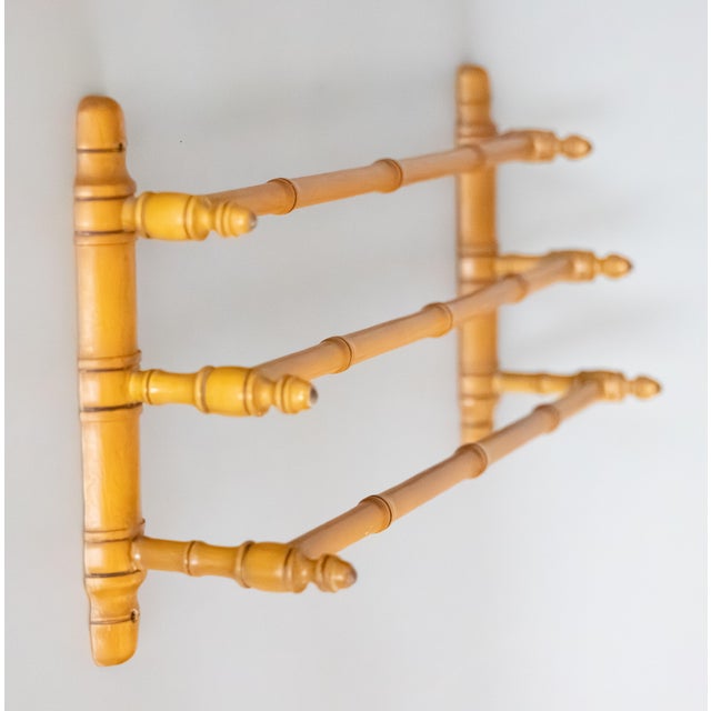 A stylish antique French wall-mounted faux bamboo hand carved triple towel rack, circa 1920. This charming rack has three...