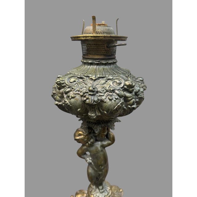 Vintage Embossed Metal Parlor Table Lamp with Figural Cherub Cupid Base In good condition showing some typical age-...