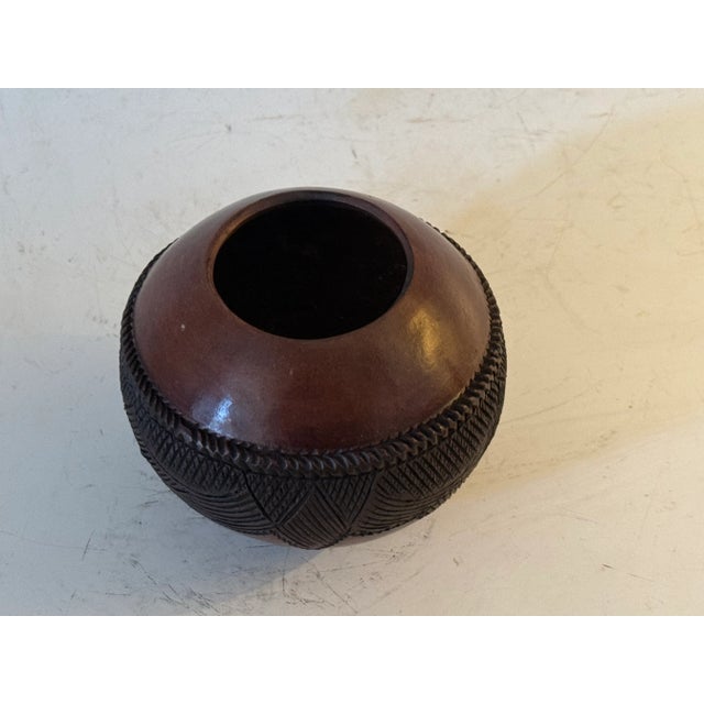Beautiful hand built Zulu Beer Cup with redish/black burnished surface. Jabulile Nala Zulu ceramics play a central role in...