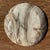 A small, round tray, dish, or plate made of petrified wood. Petrified wood is a fossilized wood (from the same family as...