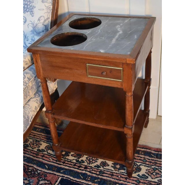 French wine table Directoire period, circa 1800-1810, is an example that carries a beautiful gray-green and white veined...