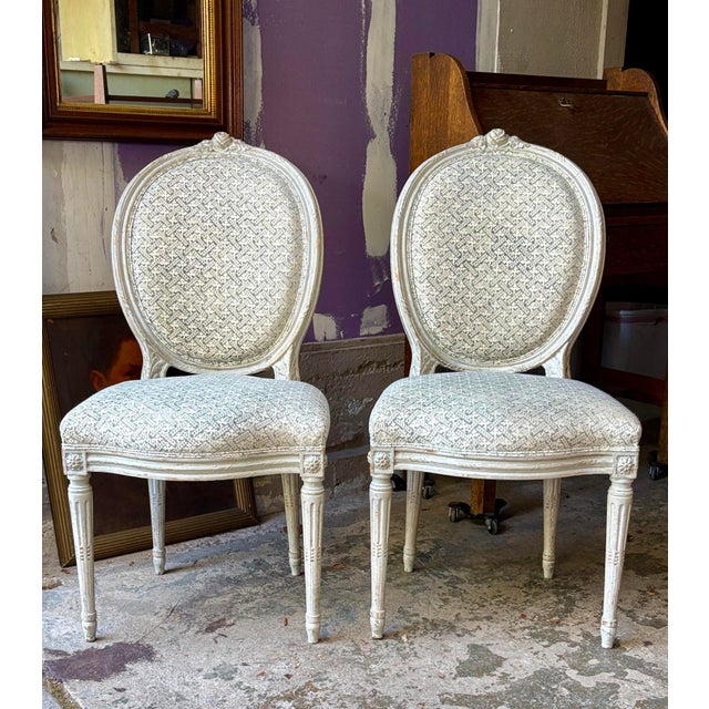 Charming pair of French white chairs with a beautiful Rose Tarlow print upholstery. There are no tags or markings.