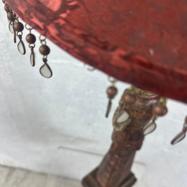 A striking vintage carved wood figural lamp depicting a serene temple guardian or deity figure standing in a prayerful...