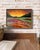 The painting titled ""Sunset Behind the Forest"" is a striking depiction of nature's vibrant transformation during the...