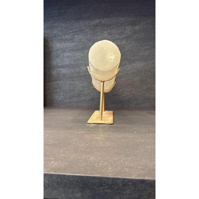 A striking modern selenite block lamp mounted on a sleek metal stand. Features natural translucent crystalline textures...