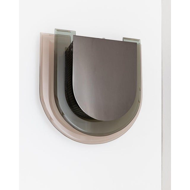 This rare vintage wall lamp was designed in the 1970s in Italy and made in Murano. The mix of perforated metal, thick...