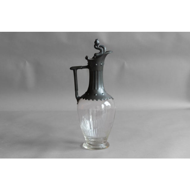 Glass claret jug with decorative pewter spout and lid. Circa 1880.