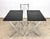 A fabulous 1970s modernist set including two folding black faux slate top tables with chrome legs together with matching...