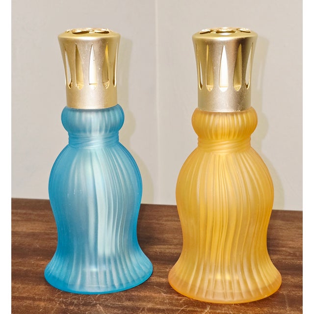 A beautiful pair of vintage Lampe Berger Paris catalytic fragrance lamps featuring frosted ribbed glass bodies and...