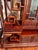 A showstopping centerpiece featuring staggered shelving, intricate cloud/scroll latticework, a glass-front accent cabinet,...