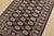 A tribal Bokhara rug hand-knotted with fine wool on a cotton foundation. This rug features rows of repeating medallions...