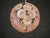 Sputnik chandelier with 51 pink glass daisy-shaped elements, supported by a burnished brass structure. The flowers' fluted...