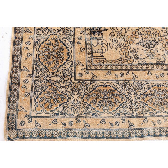 This oversized vintage Indian carpet, dating back to the 1920s, is a striking testament to the refined artistry and...