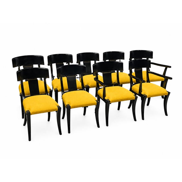 Modern set of Klismos style dining chairs. The set consists of 6 armless and 2 captains chairs. The chairs are well made...