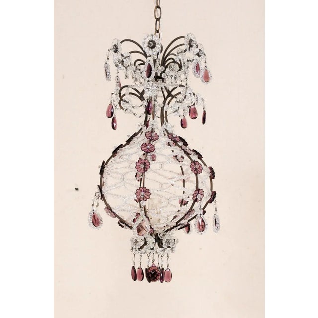 An Italian crystal and glass single-light chandelier from the mid 20th century. This vintage Italian chandelier features a...
