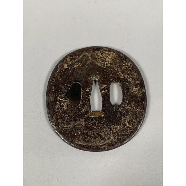 Tsuba Maru-Gata, Edo period (1603-1868). Wrought iron inlaid with copper, silver, and gold. Depicts a sage seated by a...