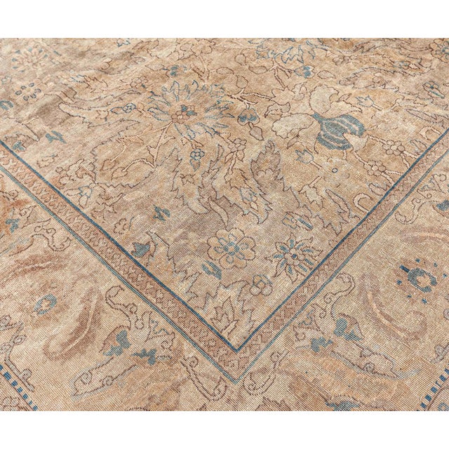 An early 20th century north Indian rug, having a design of jagged-edged leaves, fleurons and polychrome palmettes in a...