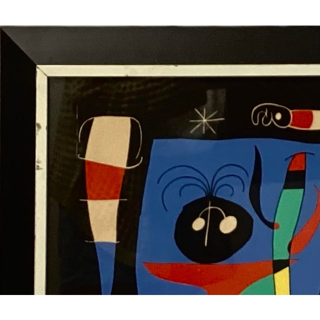 Joan Miro (1893-1983, Catalan) print titled, " Woman With A Mirror" Lithograph. Abstract style has vivid colors of red,...