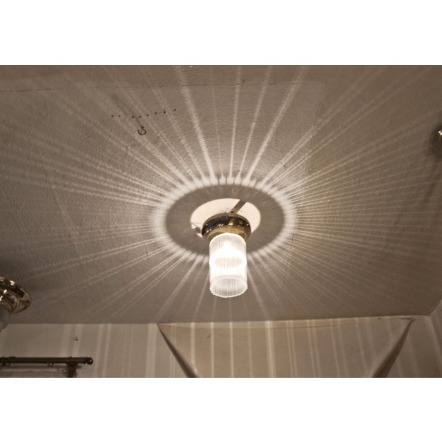 Art Deco ceiling lamp, circa 1920. Curved brass ring. Replaced glass rods. The lamp has been completely overhauled. Brass...