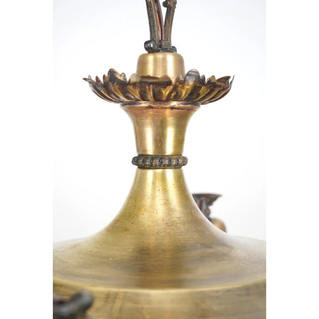 Victorian style chandelier made of brass with four exposed bulbs. The chain is made of steel. This requires four standard...