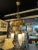Antique Brass Three Light Tudor Revival Quatrefoil Pattern Chandelier. Unique frosted Steuben style globes as shown....