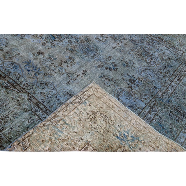 Beautiful Vintage Overdyed hand-knotted wool rug with a blue field. This Persian rug has black and gray accents in an all-...