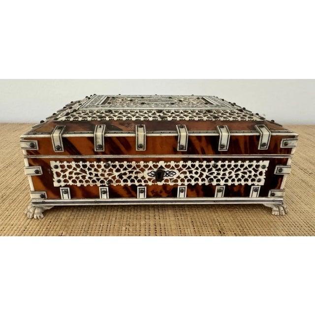 Anglo Indian box. Paw feet. Interior is lined in blue velvet.