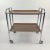 Mid-Century Modern, vintage serving tea cart consisting of laminated wood and chrome. Produced in Germany in the 1950s....
