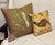 A distinctive pair of custom decorative pillows featuring richly patterned linen textiles with a collected, English...