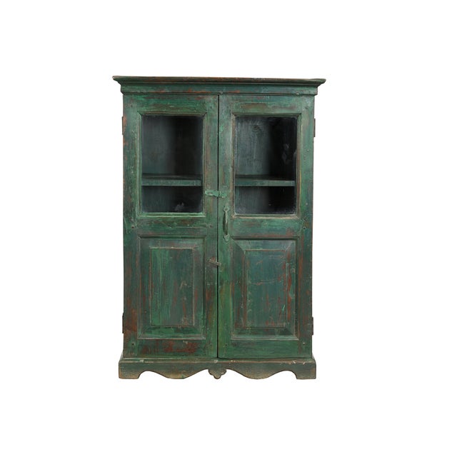 This Vintage Indian Painted Teakwood Small Bookcase/Cabinet is handcrafted featuring glazed upper doors for display and...