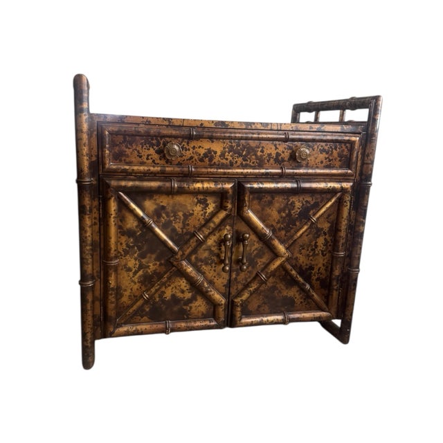 This beautiful chinoiserie side cabinet features a gold tortoise look to enhance the faux bamboo accents. Perfect as a...