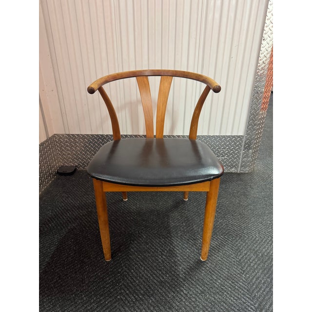 A handsome set of four vintage Danish dining chairs in the classic wishbone/Y-back tradition: the silhouette made iconic...